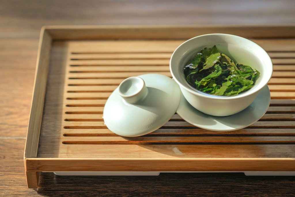 فنجان چای با درب روی سینی چوبی